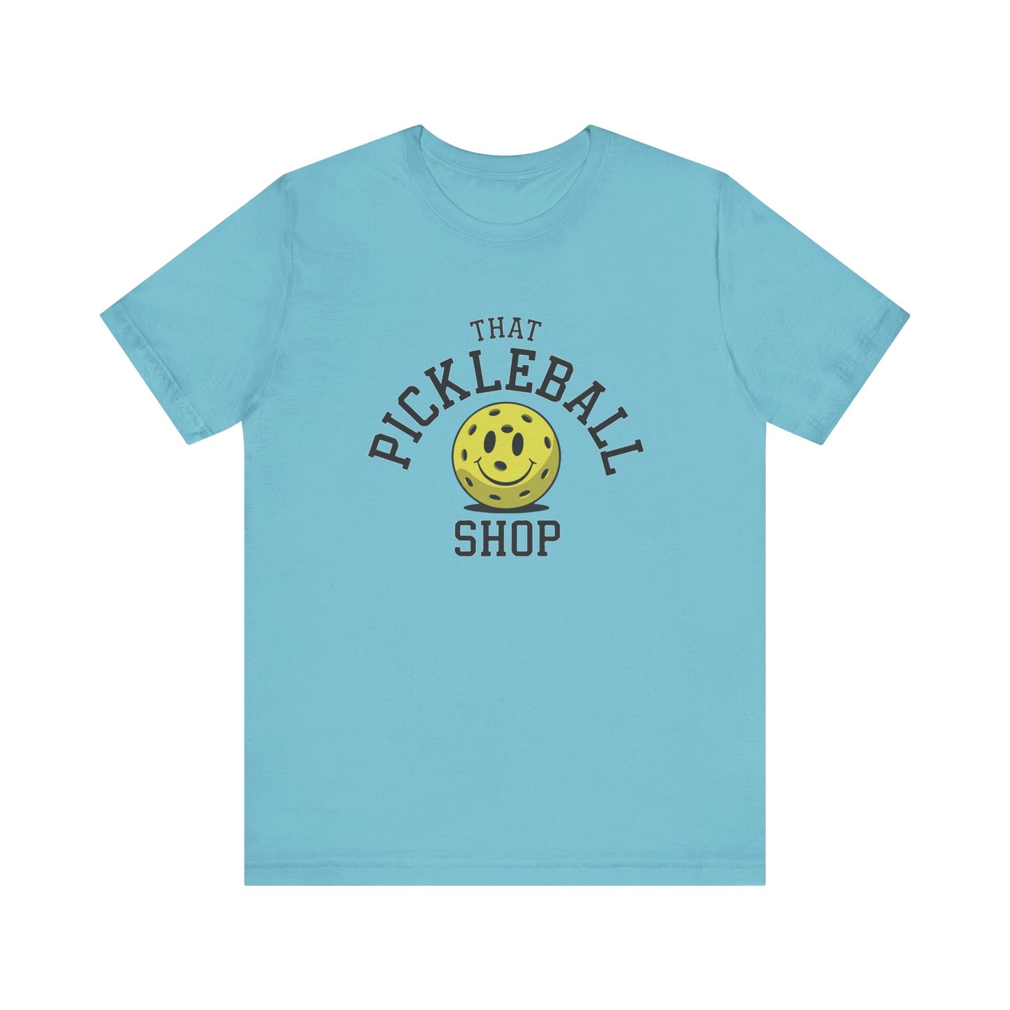 T-shirt Aqua That Pickleball Shop logo with a yellow pickleball smiley face.