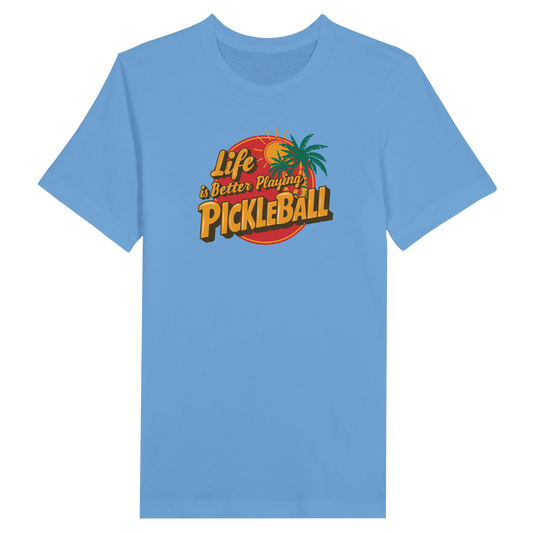 Light blue pickleball t-shirt with “Life is Better Playing Pickleball” graphic featuring palm trees and a sun.