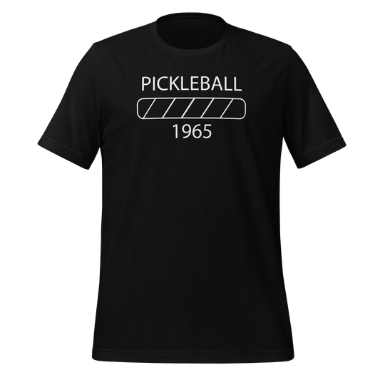 t-shirt featuring a minimalist design with the text “Pickleball 1965” and a progress bar graphic in white.