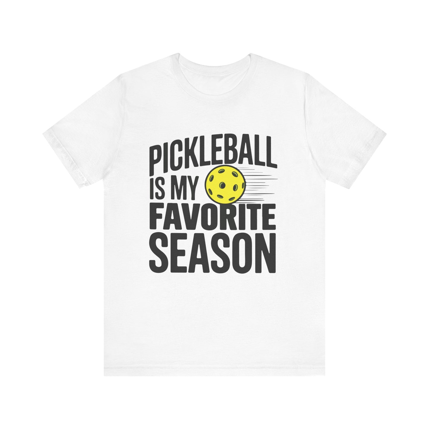 White t-shirt with bold black text saying “Pickleball Is My Favorite Season” and a yellow pickleball graphic in motion.