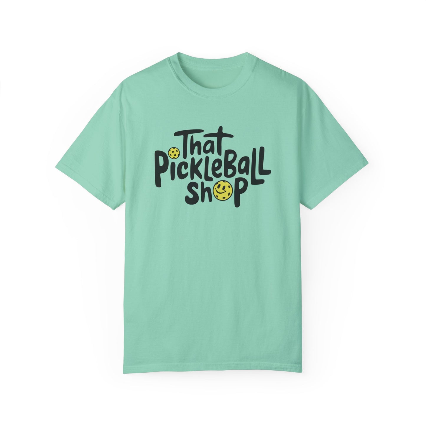 T-shirt in an alternate color featuring the same playful pickleball logo with a pickleball replacing the dot over the “i.”
